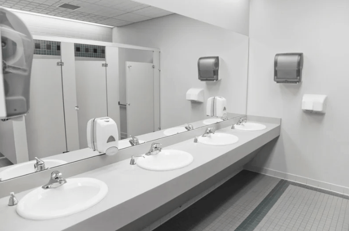 A long-view of a row of public bathroom sinks.