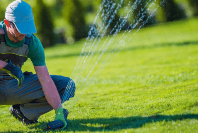 man outside with sprinkler system