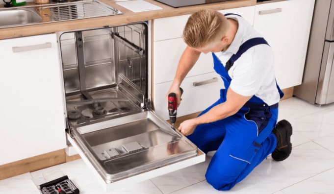 man working on dishwasher