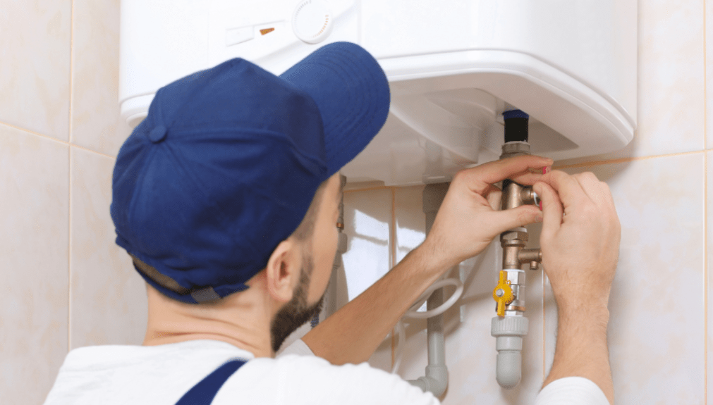 plumber repairs water heater